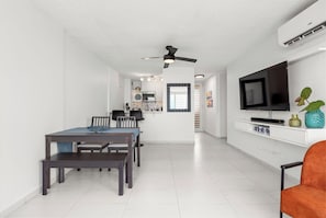 Relax in this stylish living space with a dining area, flat-screen TV, and comfortable seating.