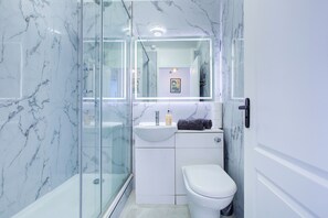 Shower, towels, soap, toilet paper