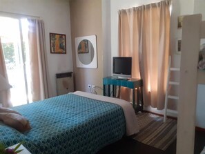 Relax in this cozy space with a large bed and a TV for entertainment.