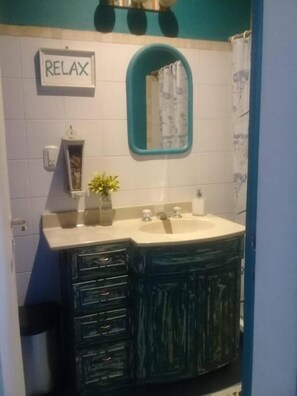 Sink and bathtub area with a relaxing ambiance.