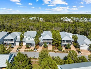 A residential area with multiple houses, each with a similar architectural style, featuring gabled roofs and front porches.