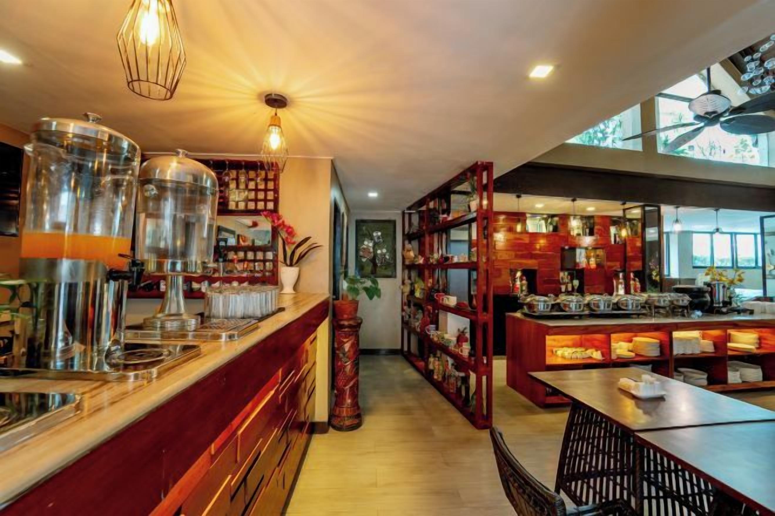 A bar area with a counter, shelves with bottles, and a seating area with tables and chairs.