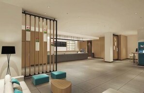 A spacious hotel lobby with a reception desk, seating area, and a view of the kitchen in the background. - JILUN HOTEL (Zhoushan)