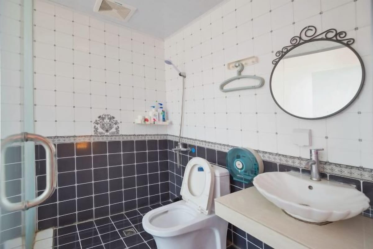 A bathroom with a toilet, sink, and shower.