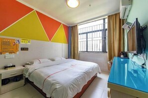 Simple, functional design with a single bed, bedside table, and flat-screen TV.