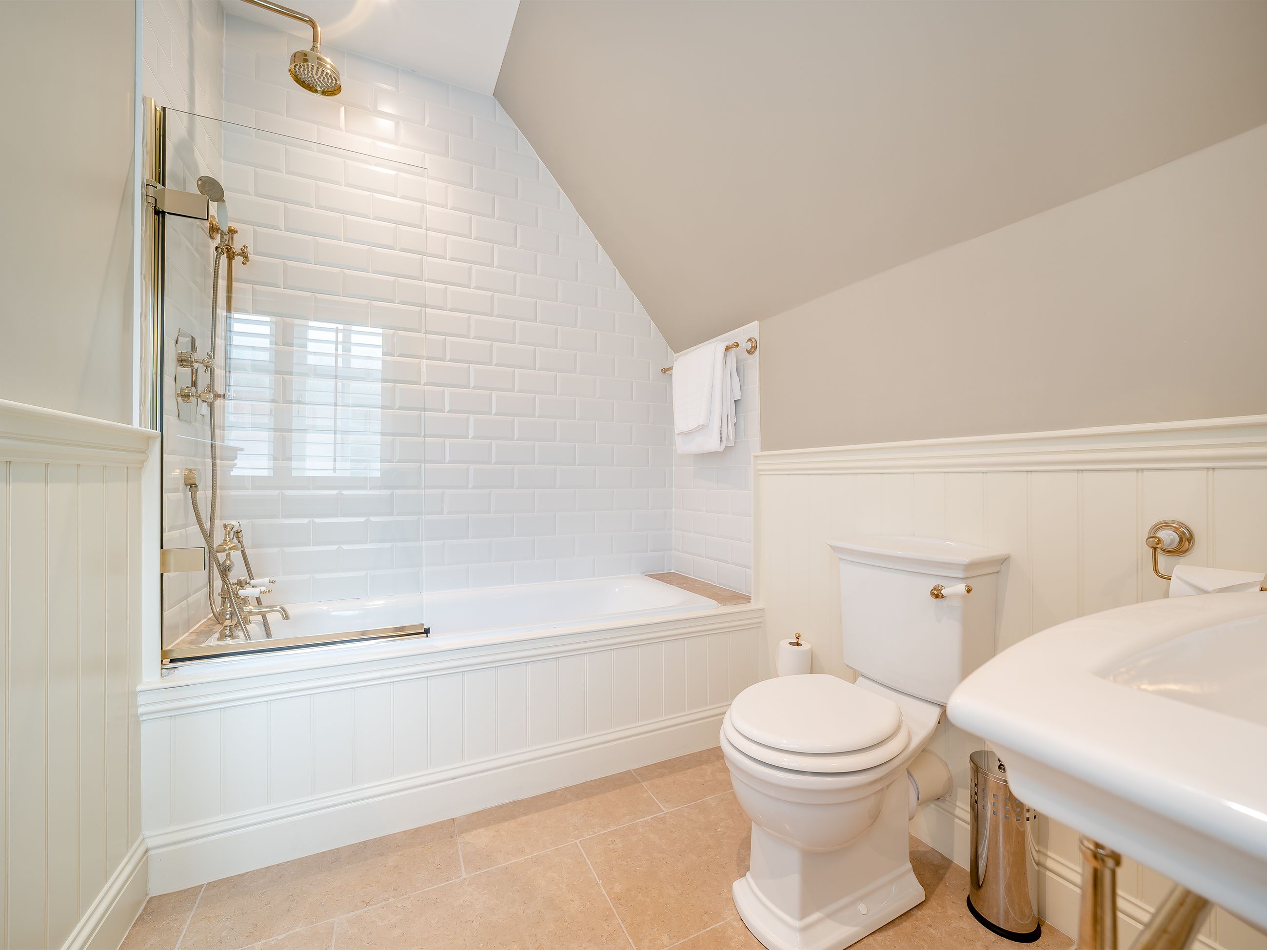 A bathroom with a bathtub, toilet, and sink.