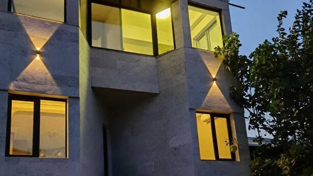 A modern multi-story building with large windows and a checkered floor pattern. - HAYQ BOUTIQUE HOTEL (Yerevan)