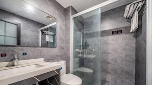 A modern bathroom with a glass shower enclosure, a white toilet, and a marble vanity. - Box Space Xinzhiwan Hotel (Shanghai Bay University City Branch) (Shanghai)
