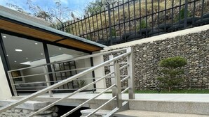 A staircase with metal railings leading to a building entrance. - 2BR duplex with city views.  "Casa Colibrí" (Cuenca)