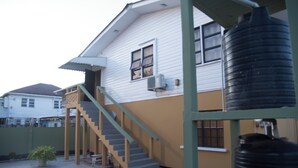 A two-story house with a staircase leading to the upper floor.