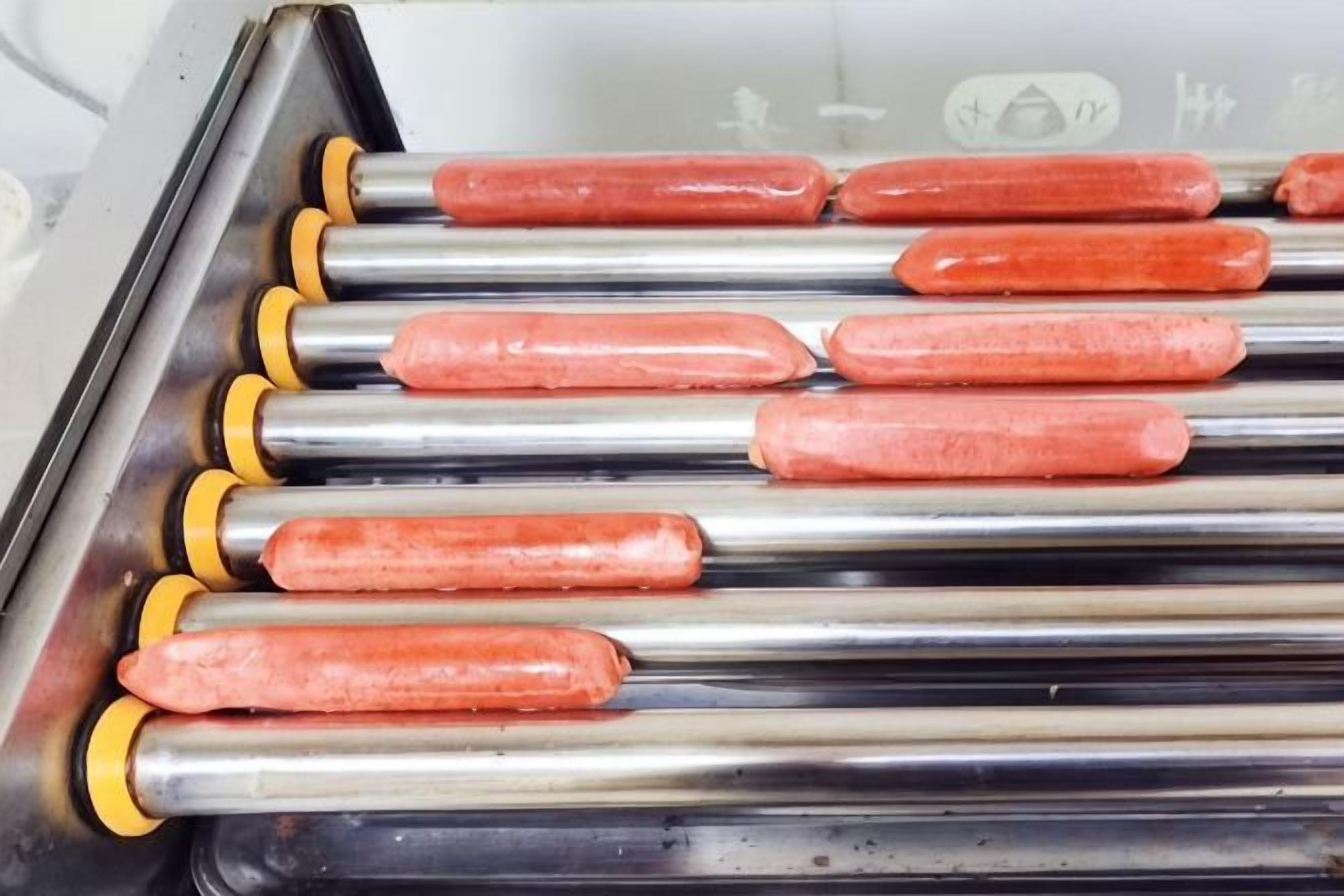 A row of metal rods with handles, likely part of a kitchen appliance.