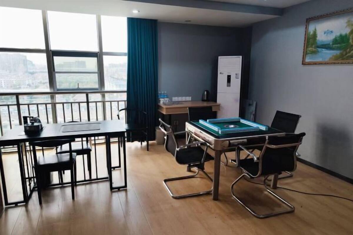 A modern room with a pool table, a desk, and a chair.