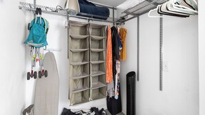 A storage closet with shelves, a hanging rack, and a shoe rack. - 8ft Deep Heated Pool, 9 Seat Medical Grade Jacuzzi, Mini-Golf & Chef’s Kitchen! (San Diego)