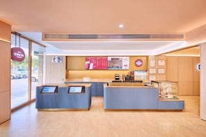 A reception area with a counter, a display case, and a seating area. - HanTing Hotel (Zhuhai Jinwan Airport) (Zhuhai)