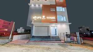 A modern multi-story building with a prominent sign reading "JNS Arcade" and "cloud" logo. - Hotel Cloud 9 Luxury stay - Mysore (Mysore)