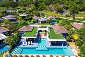 A resort with multiple buildings, a central swimming pool, and lush greenery. - 5 Bedroom Amazing Pool Villa in Resort (TS1) (Hua Hin)