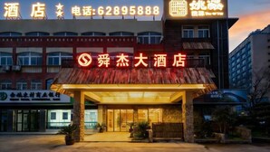 A hotel with a prominent sign displaying the name and contact number. - Shunjie Hotel (Yuyao)