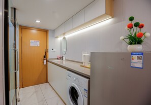 Enjoy a clean and functional stay with a washing machine, compact refrigerator, and convenient countertop area.