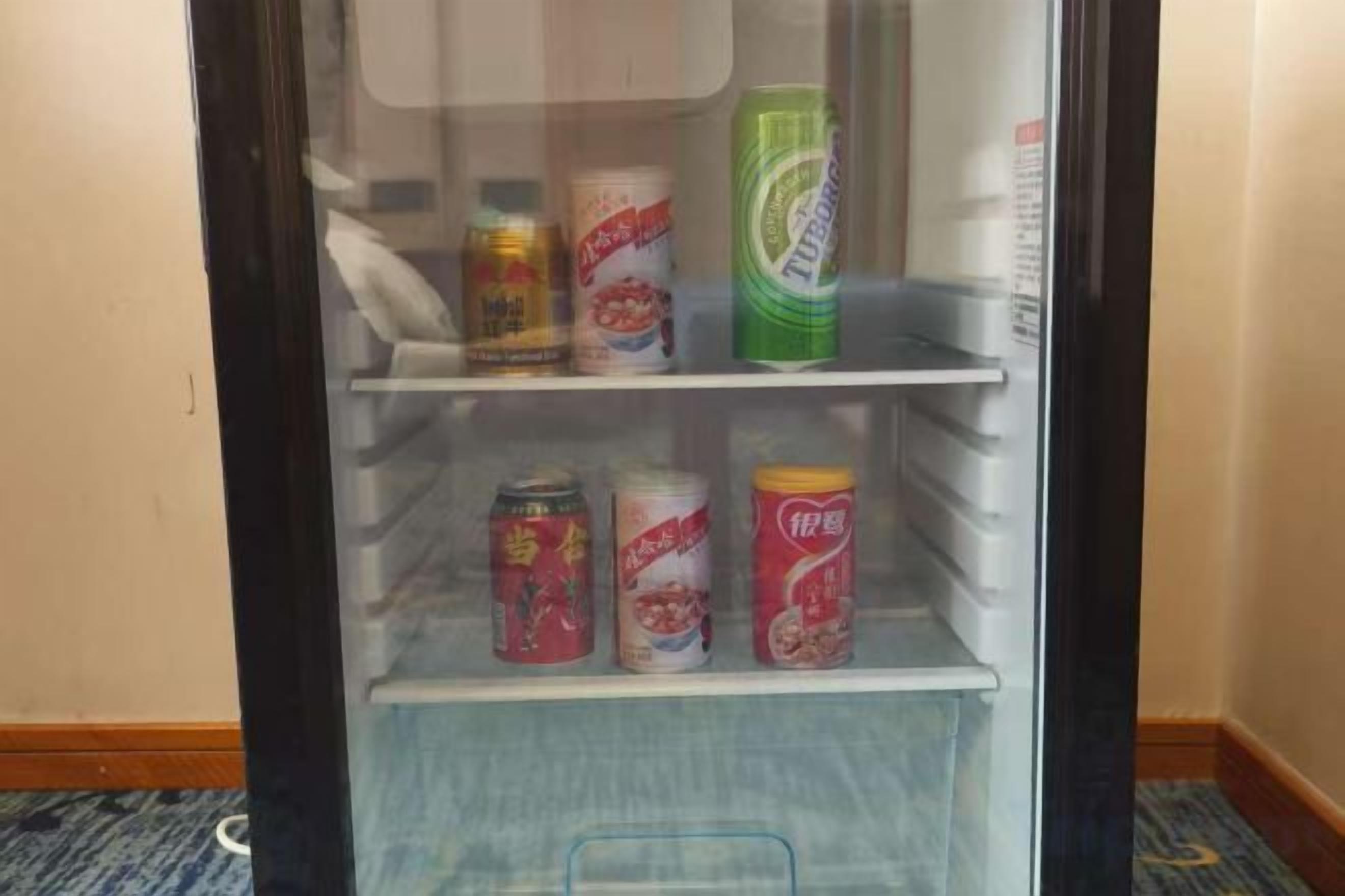 A refrigerator stocked with various beverages.