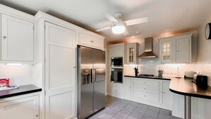 A modern kitchen with white cabinetry, a stainless steel refrigerator, a microwave, an oven, and a gas stove. - 4 bedroom accommodation in Compton Martin, near Cheddar (Compton Martin, near Cheddar)