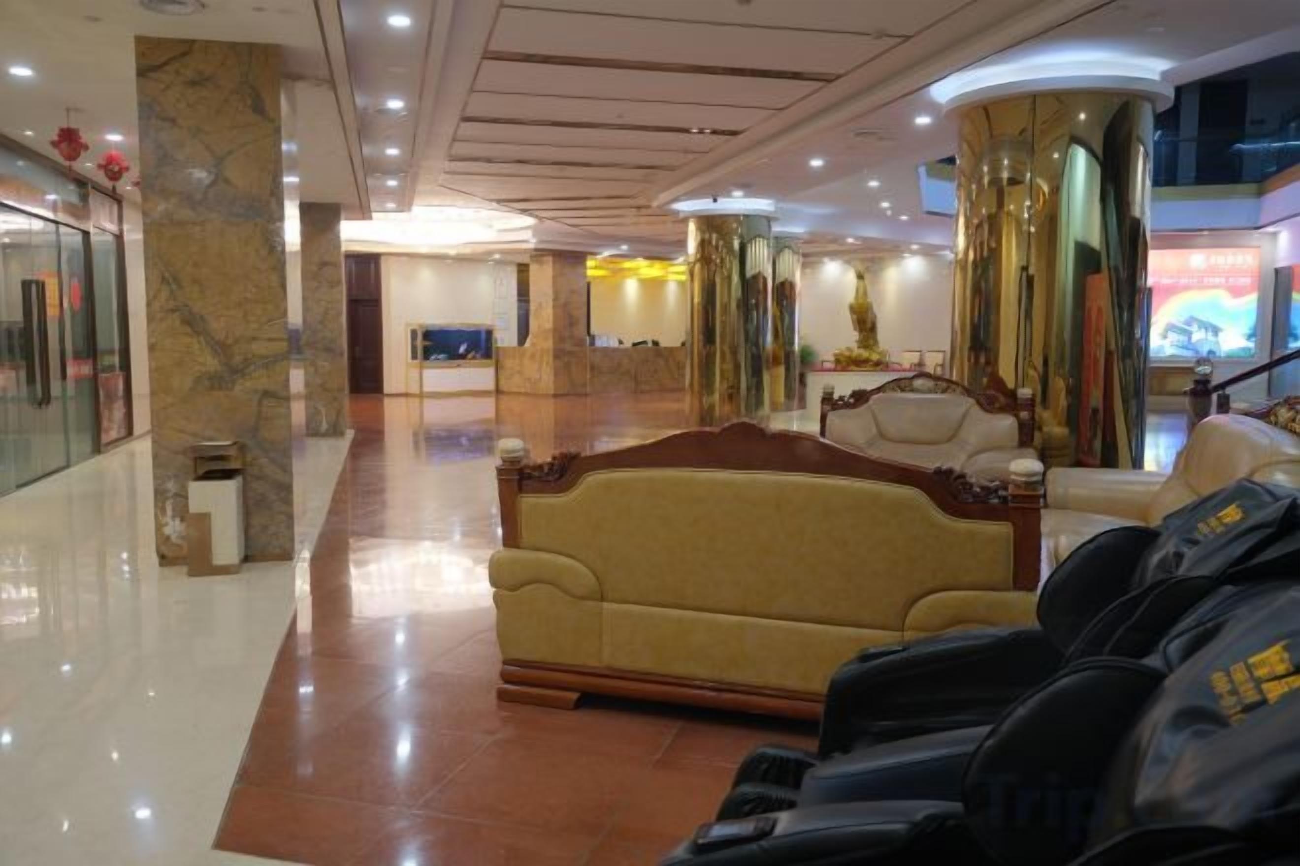 A lobby with a reception desk, a sofa, and a seating area.