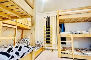 A room with bunk beds, a ladder, and a curtain. - RedDoorz Plus @ Remarkable Hotel Alcala Pangasinan (Pangasinan)