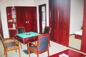 A room with a pool table, four chairs, a bookshelf, and a door. - Qingxu Haitianyu Hotel (Qingxu)