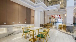A spacious dining area with marble flooring, gold-framed tables, and green upholstered chairs. - Shishi Laiya Fortune Hotel (Quanzhou South Railway Station) (Shishi)