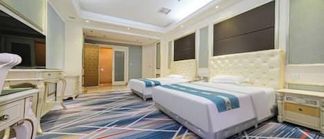 A hotel room with a large bed, a desk, and a television.
