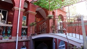 A red brick building with arched windows and a balcony with metal railings. - Fuxing No. 10 Hotel (Xiamen)
