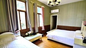 A hotel room with two beds, a desk, and a wardrobe. - Fuxing No. 10 Hotel (Xiamen)