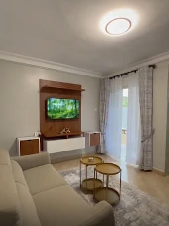 Luxury Apartment, Balcony | Living area | 48-inch Smart TV with digital channels, Netflix, streaming services. Hillz furnished Apartments