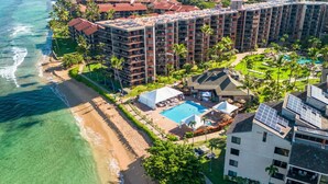A beachfront hotel with multiple buildings, a swimming pool, and a beach area. - Spacious 2 Bed with Views! (Lahaina)