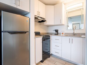 Microondas, cafetera/tetera, utensilios de cocina, mesa de comedor