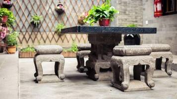 A stone table with matching stools in a courtyard.