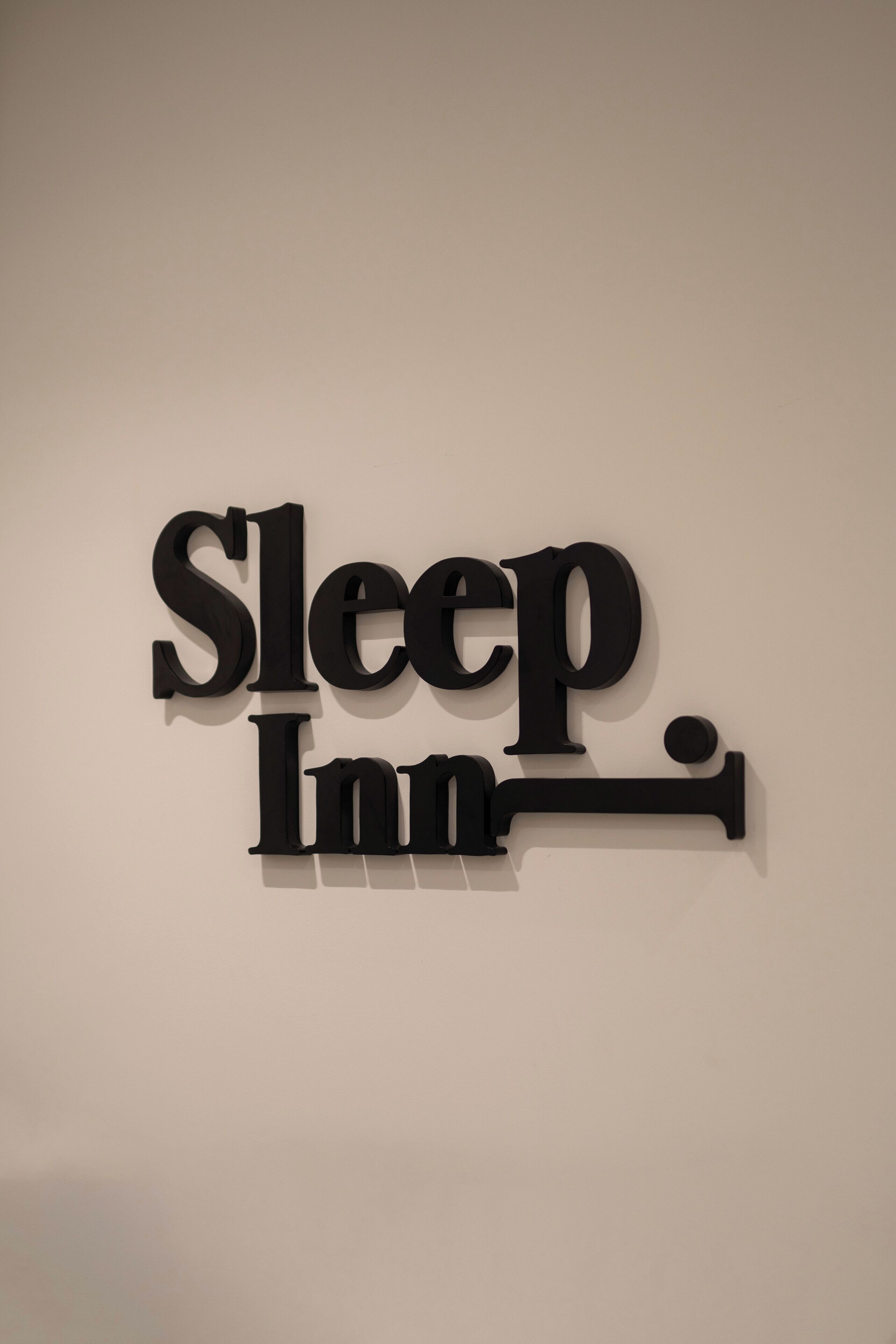 A wall-mounted sign with the text "Sleep Inn."