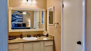 A bathroom with a large mirror, a sink, and a door. - Katy Hideaway Charming 3 Bdr! (Katy)