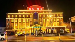 A hotel with a prominent entrance, large windows, and a sign with Chinese characters. - GreenTree Inn (Ganyu Ancient City Yinxing Avenue) (Ju County)