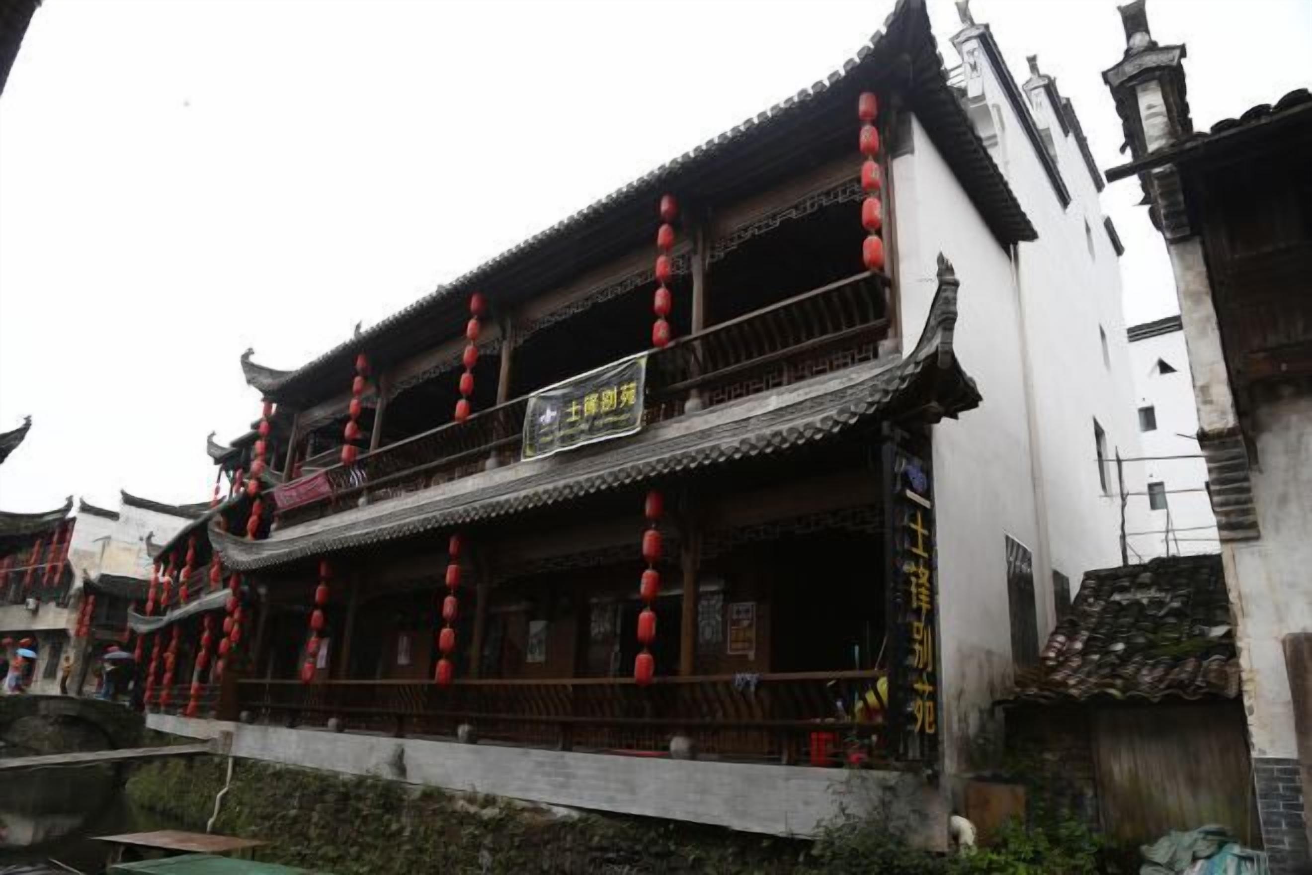 A traditional building with multiple balconies and red lanterns.