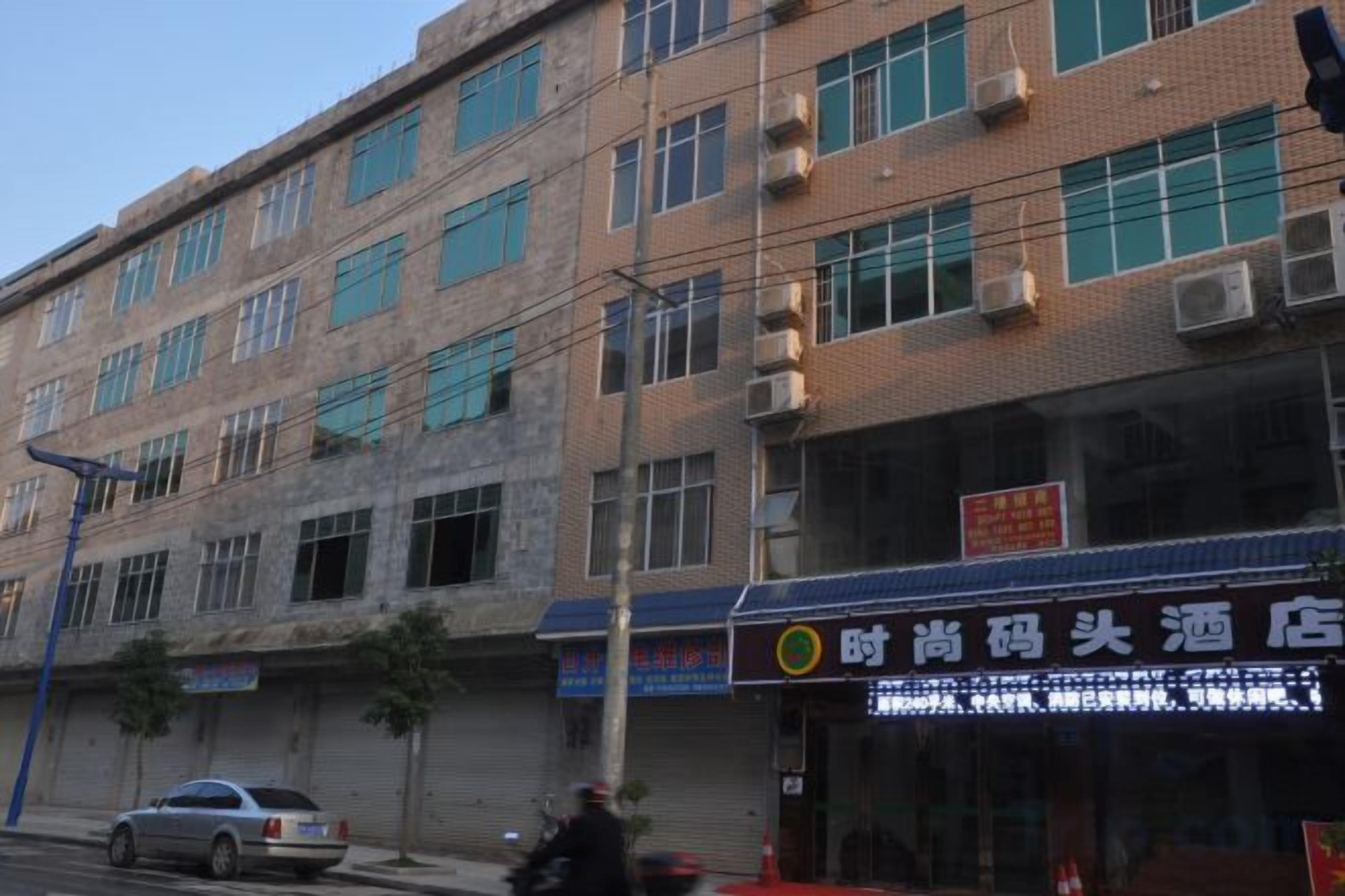 A multi-story building with a storefront on the ground floor.