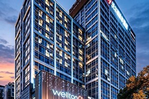 A modern hotel building with a prominent 'Wellton City' sign. - Wellton City Hotel (Ganzhou Railway Station) (Ganzhou)