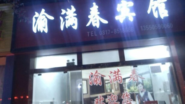 A hotel sign with Chinese characters and a contact number.