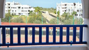 A balcony with a view of a residential area, featuring white buildings and a clear sky. - Family spacious apartment with sea view, AC, WiFi, 7 mins walking to the beach (M'diq)
