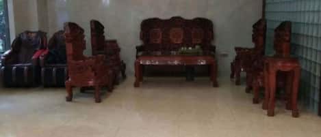 Una habitación con un conjunto de sofá, sillas y una pequeña mesa.