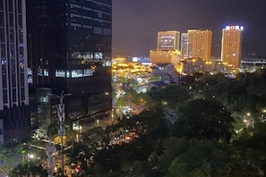 A nighttime cityscape with illuminated buildings and busy streets. - Yiting Hotel (Chongqing)
