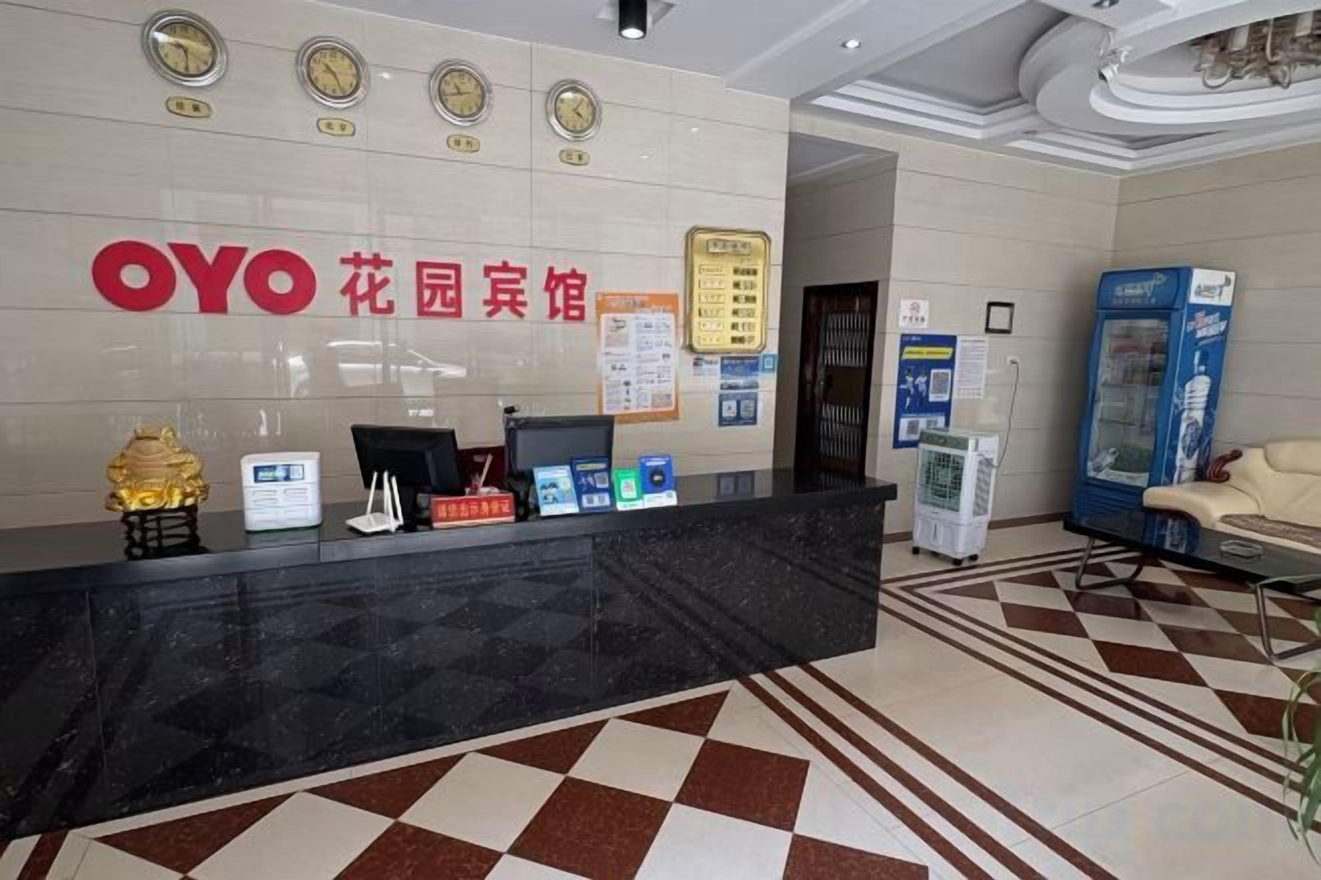 A reception area with a reception desk, a clock, a bulletin board, and a vending machine.