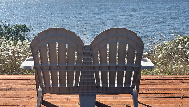 Two Adirondack chairs facing a body of water with a clear sky. - Lakefront Ranch with Hot Tub and WiFi in Crescent City (Crescent City)