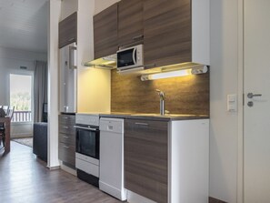 A modern kitchen with a microwave, oven, and dishwasher.