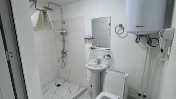 Shower, hair dryer, slippers, towels