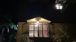 Um edifício com uma grande janela arqueada e uma pequena varanda.